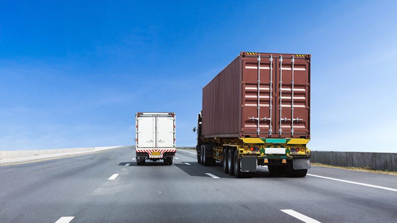 Truck on highway road with container, transportation concept.,import,export logistic industrial Transporting Land transport on asphalt expressway with blue sky